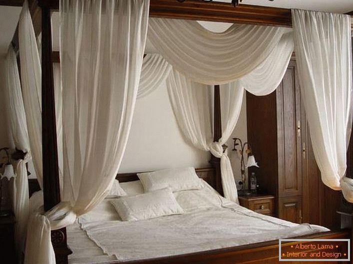 A white canopy over a simple, laconic bed made of wood.