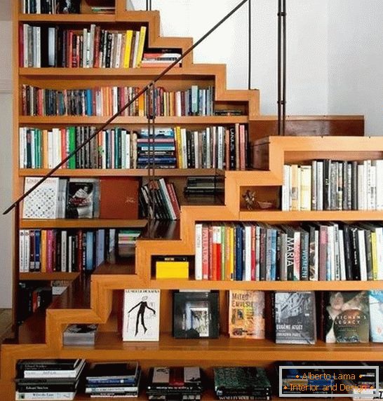 Bookcase under the stairs in a private house Photo
