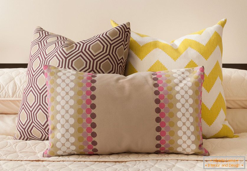 Bright yellow and beige decorative pillows with interesting prints