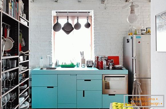 A small kitchen with a large dish rack