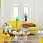 Sofa of mustard color in white interior