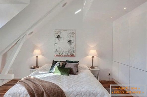 Interior of a small attic bedroom в белом цвете