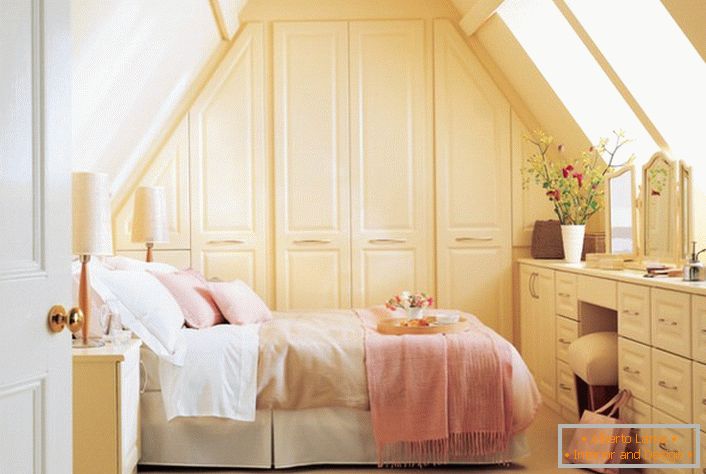 The bedroom in the rustic style is decorated in soft pink and beige tones.