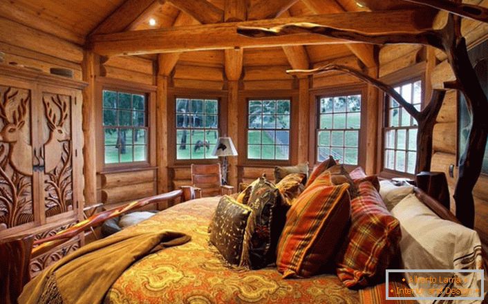One of the bedrooms in the house near the lake is made in the style of rural country. Wooden decoration. Massive furniture and decor elements are selected in the best traditions of style.