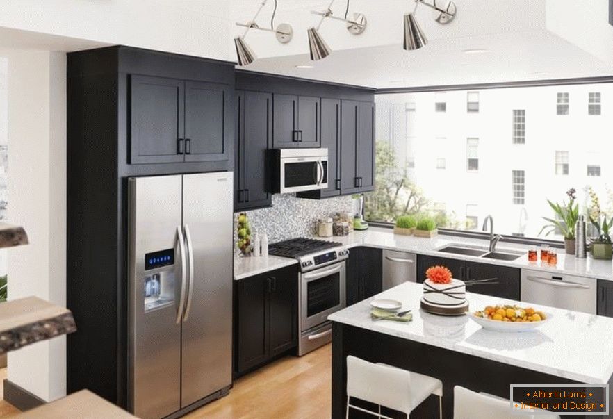 The combination of a steel refrigerator and dark furniture in the kitchen