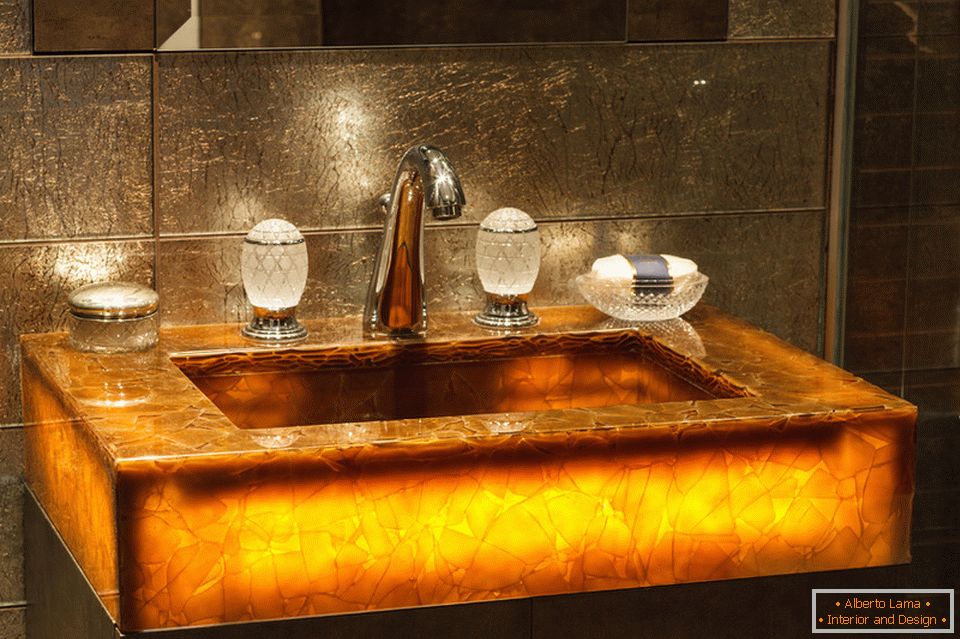 Sink with lighting in the bathroom of a bright studio apartment