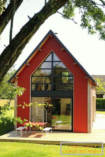 Interior of a small wooden house with large windows