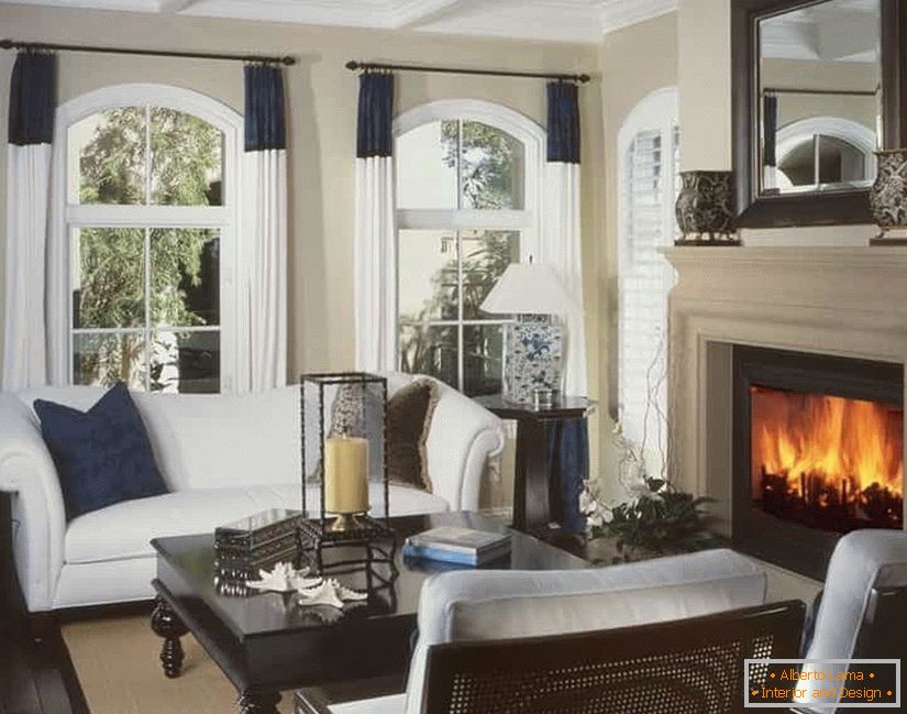 The design of the living room in the house with a fireplace in front of the sofa corner