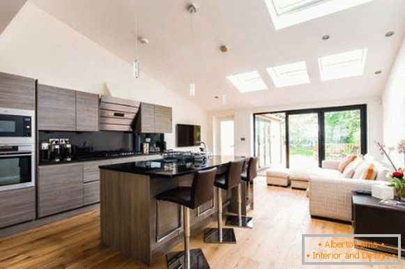 Interior of a combined kitchen living room in a private house in a modern style