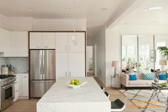 Modern interior of the kitchen-living room in a private house in white color