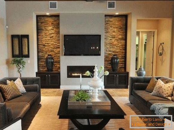 Modern interior of a living room with a fireplace in a private house - photo