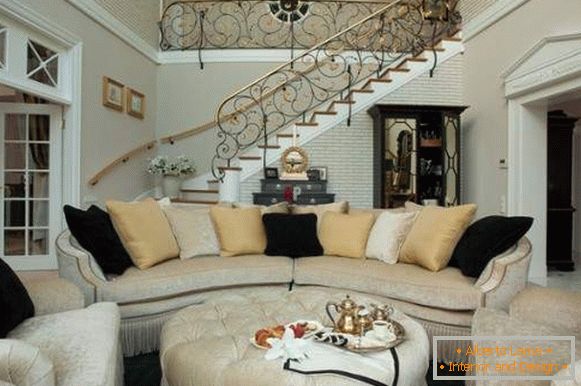 Interior of the living room in a private house with a forged staircase - photo 2017