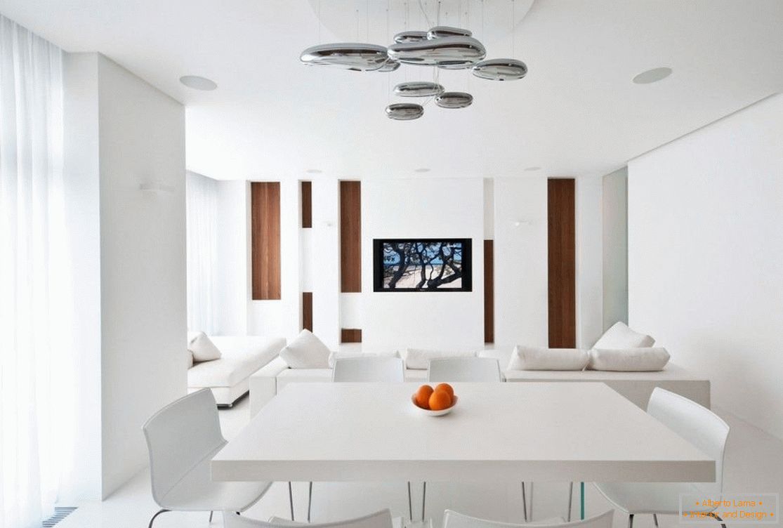 White dining area in the interior of a one-room apartment