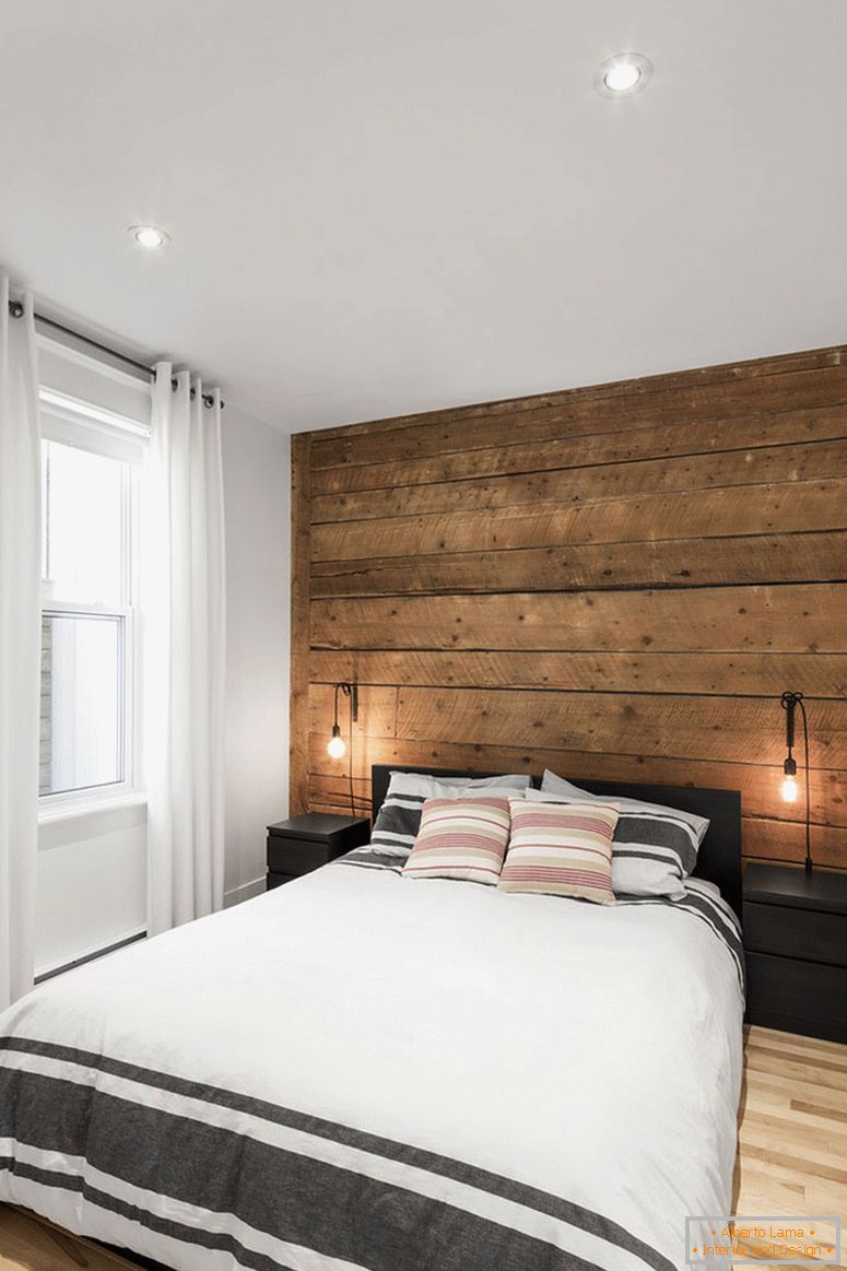 Wooden accent wall in the interior of a small bedroom