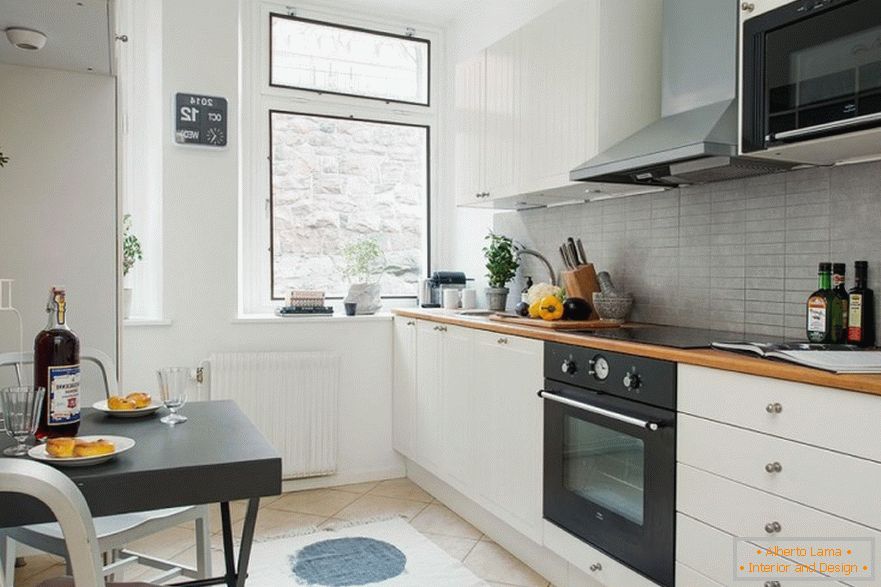 Black furniture in the interior of a small white kitchen