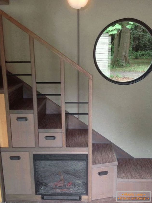 Electronic fireplace under the stairs in a small country house