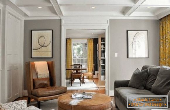 Gray beige color in the living room interior with yellow curtains