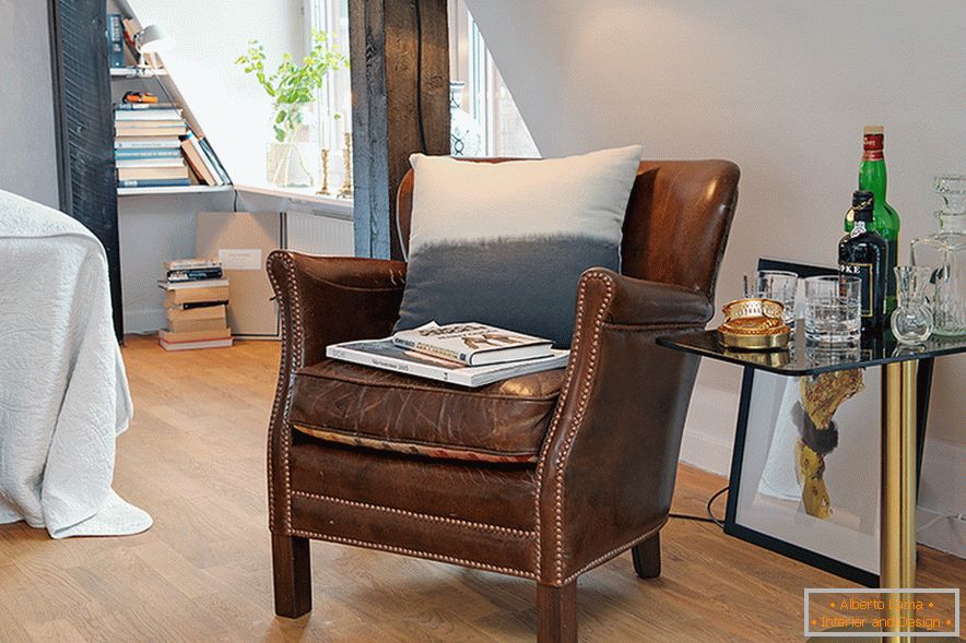 Armchair in the interior of a cozy attic in a Swedish city