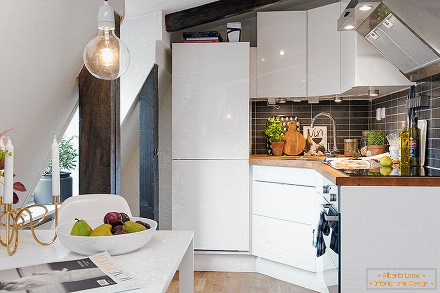 Kitchen area in the design of a cozy attic in a Swedish city