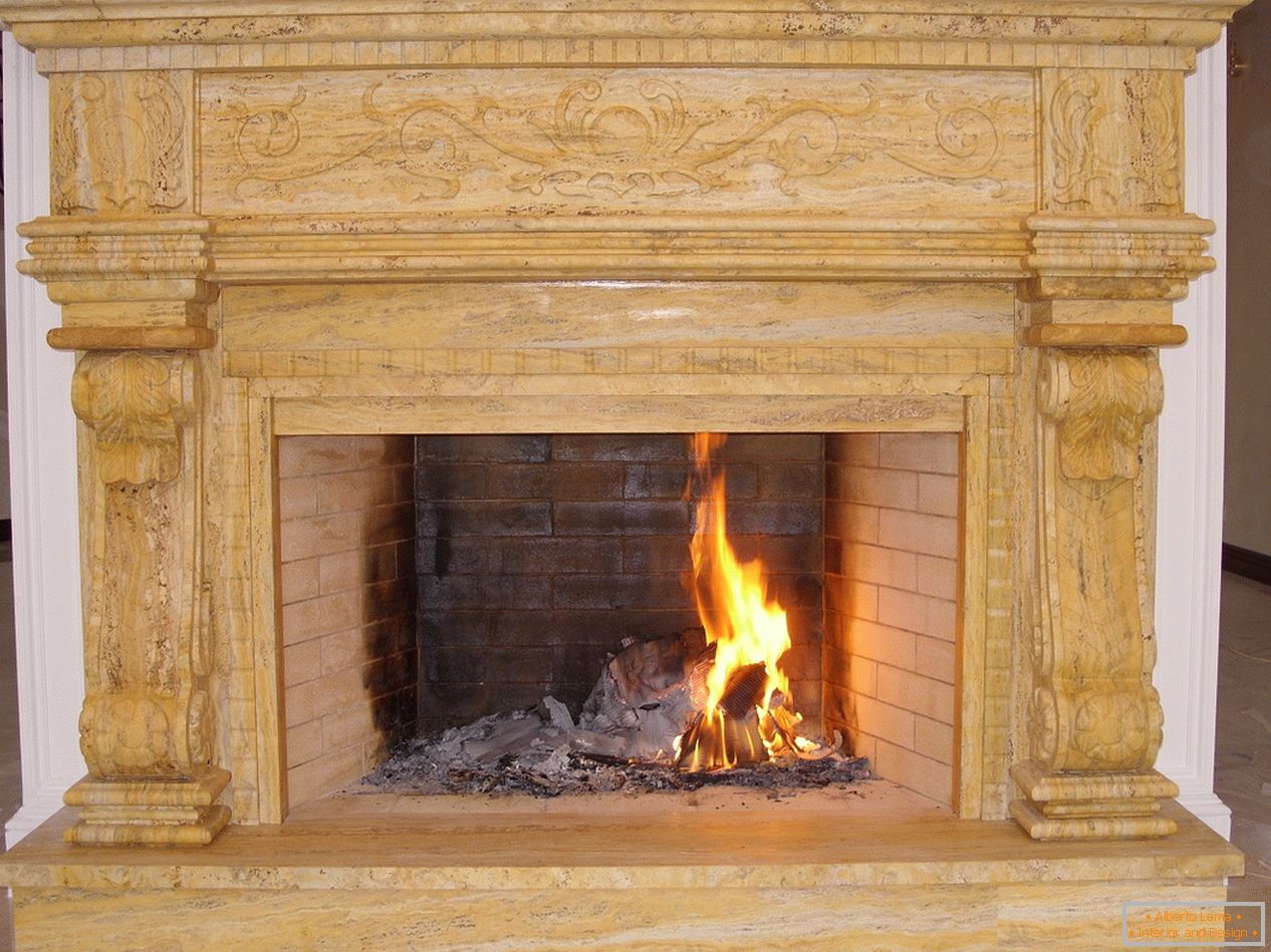 Noble fireplace made of bricks with decorative elements of dark wood in a Moscow country house.