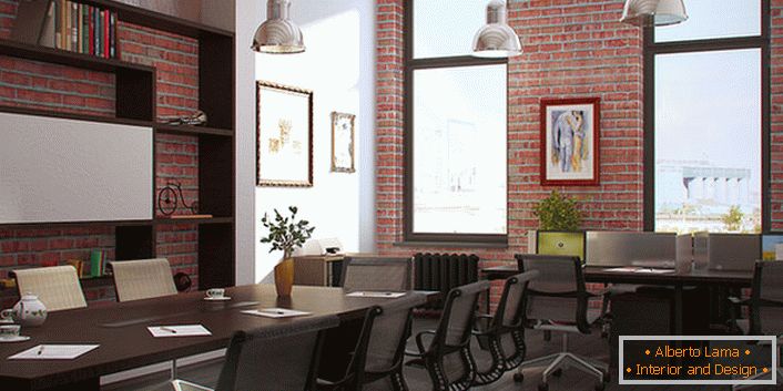 The loft-style office is decorated in red brick. Functional solution for a large room.