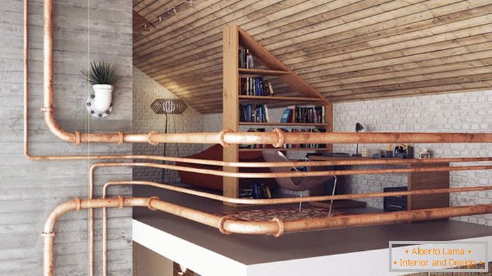A cozy office on the second floor is fenced with metal pipes, which corresponds to the loft style. 