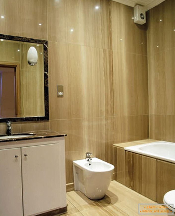 Laconic interior of the bathroom in the style of minimalism organically fits into a small space.