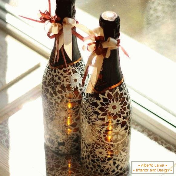 Decor of a bottle of champagne with lace and ribbons