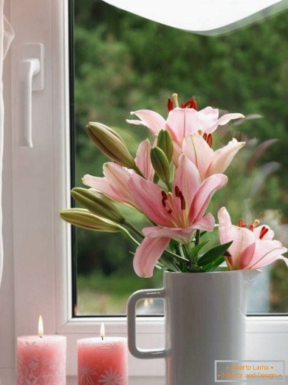 Candles and flowers on the windowsill
