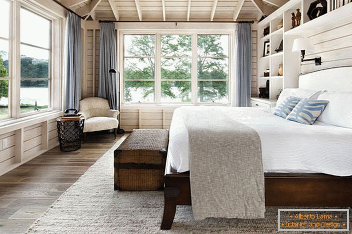 A bedroom in Scandinavian style with a large double bed made of wood in the house of a French businessman.