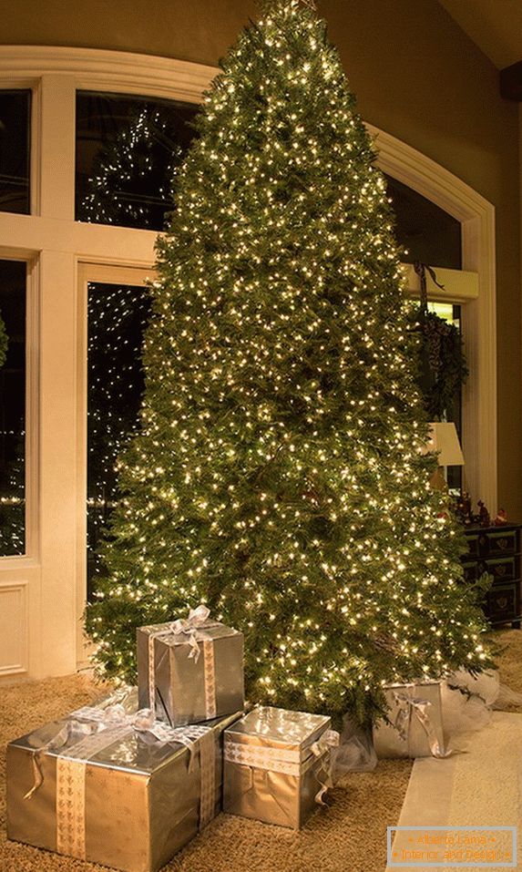 Unusual decoration of a huge Christmas tree with garlands