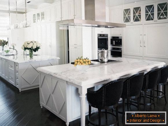 White kitchen with marble countertops and black floor