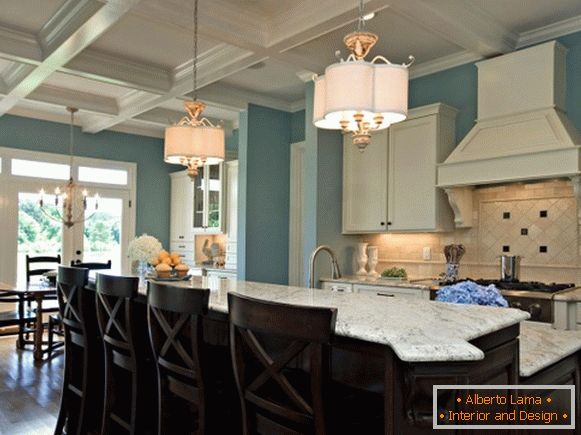 Kitchen with blue walls and a black island