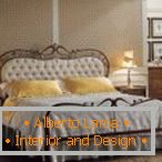 Wrought-iron bed with a soft headboard