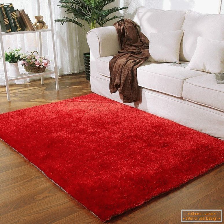 Red carpet in front of a white sofa