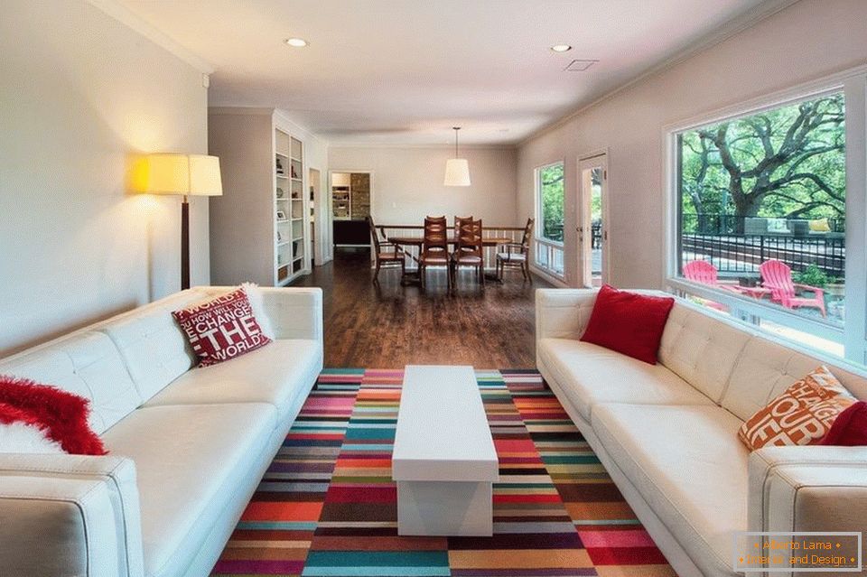 Living room with white sofas and colored carpet