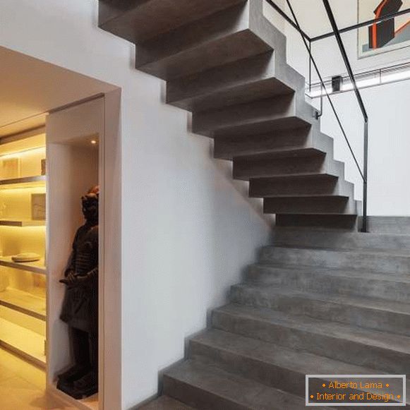 Stylish concrete staircase in the house on the second floor