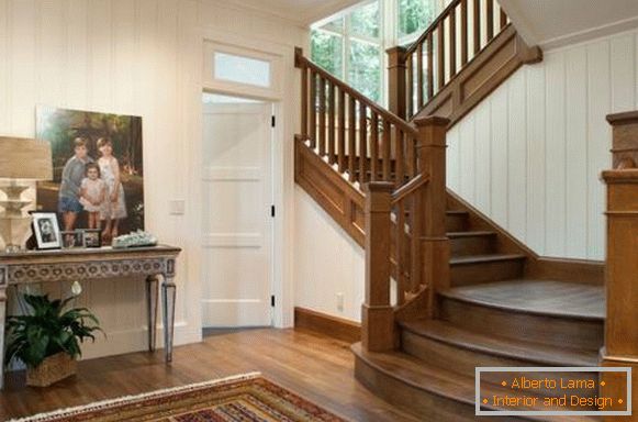 Hall with a wooden staircase in a private house - photo