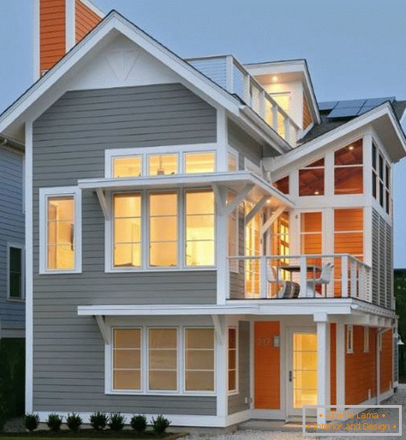The modern facade of a private house in gray and orange color