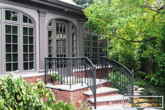 Forged railing for the porch of red brick with concrete