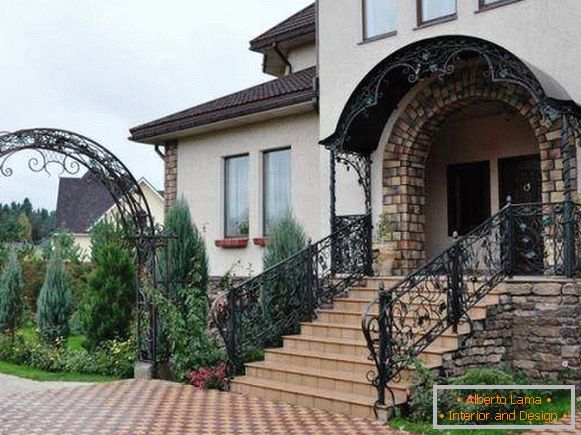 A smart forged porch with a canopy and handrails