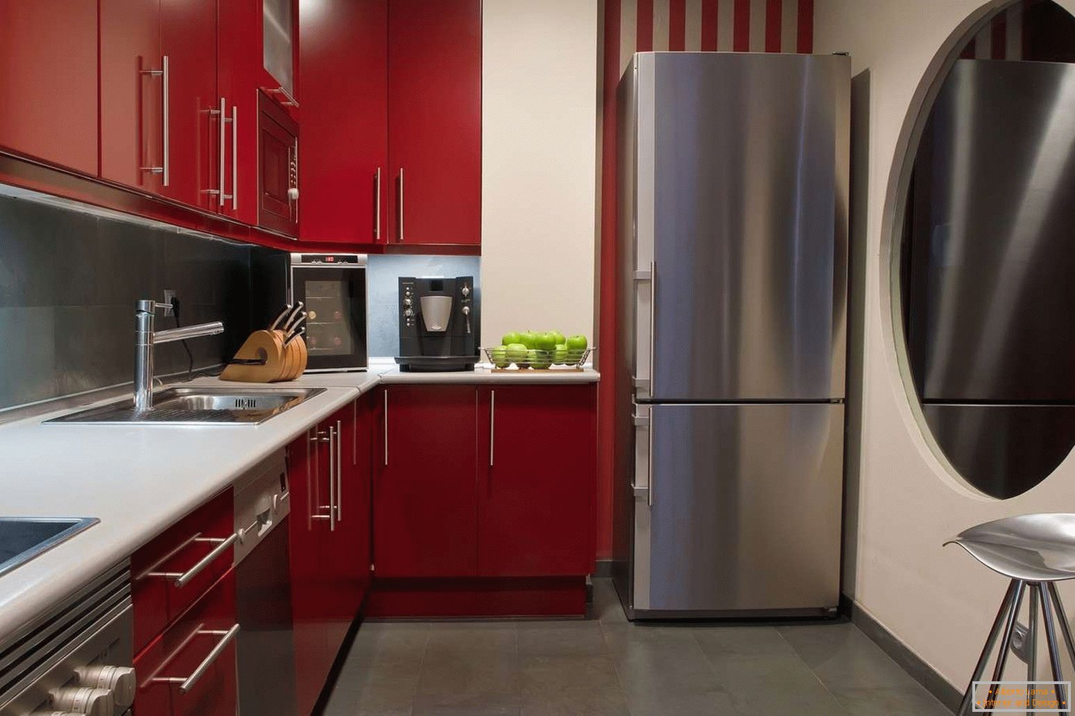 Gray floor in the kitchen with red furniture