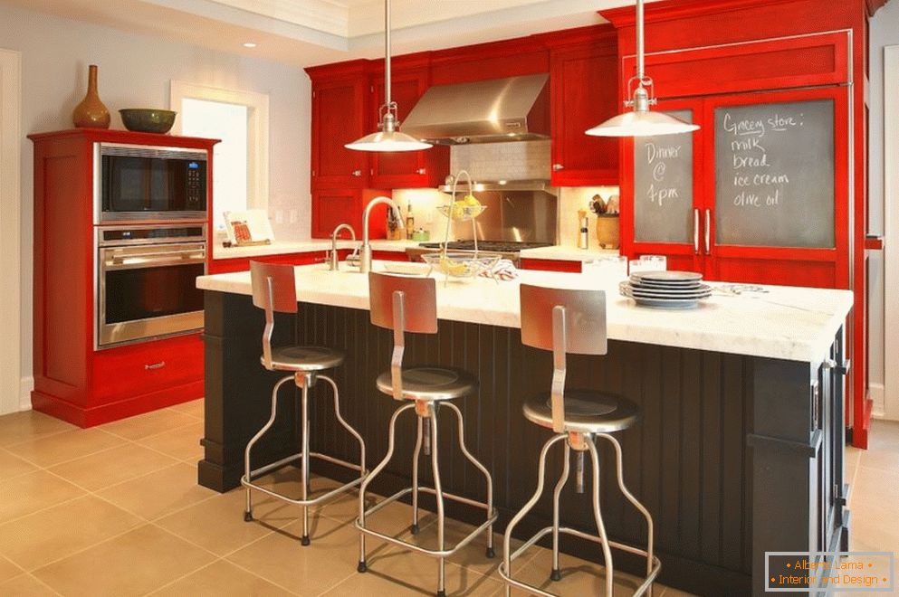 Multi-level ceiling in the kitchen with red furniture