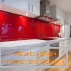 White furniture and a red apron in the interior of the kitchen