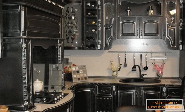 Kitchen set in black baroque style is made of precious wood. 