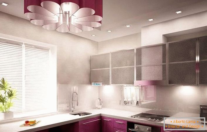 Unusual chandelier in high-tech style in the tone of the kitchen set looks elegant.