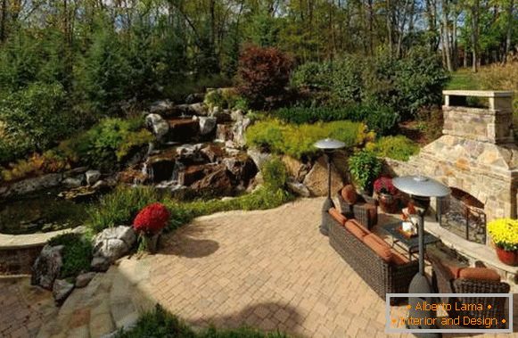 Landscaping of a country house with an artificial pond