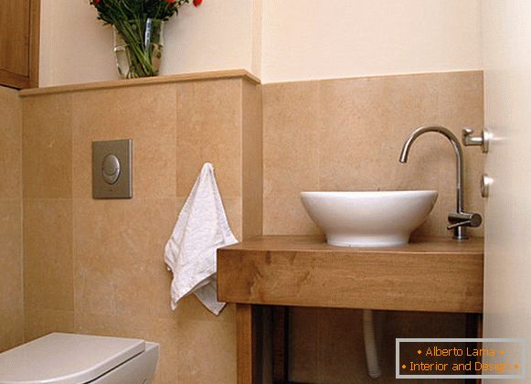 A bouquet of red flowers in a bright bathroom