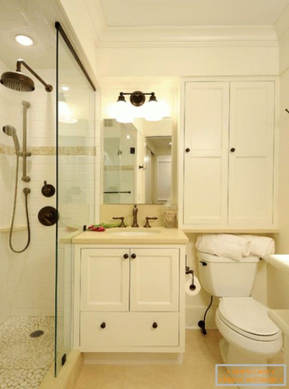 Narrow shower cubicle with glass partition in the bathroom