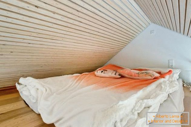 Bedroom under the ceiling in a small private house